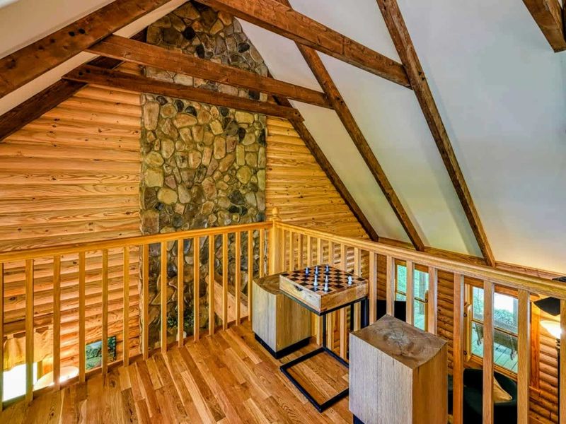 Challenge your friends to a game of chess or relax in this cozy loft space overlooking the warm, rustic interior of the cabin.