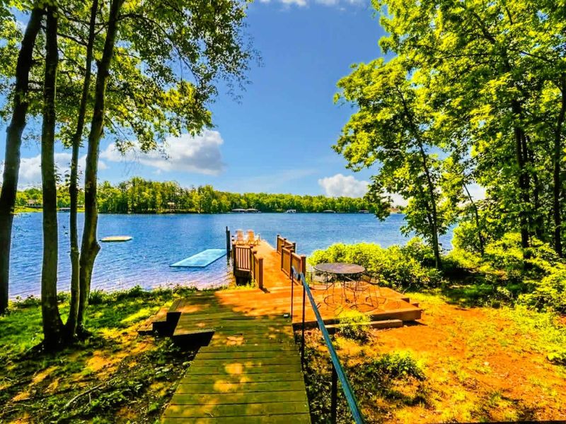 Stroll down the charming boardwalk to your private dock, where you can enjoy peaceful lake views, swimming, and dining by the water.