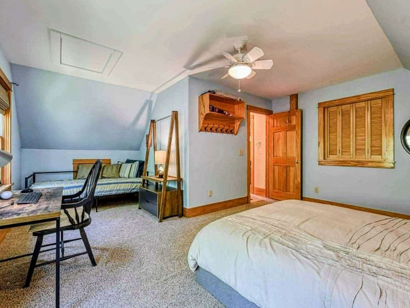 Perfect for families or groups, this large bedroom offers a comfortable queen bed and an additional day bed, along with a workspace for any needs during your stay.