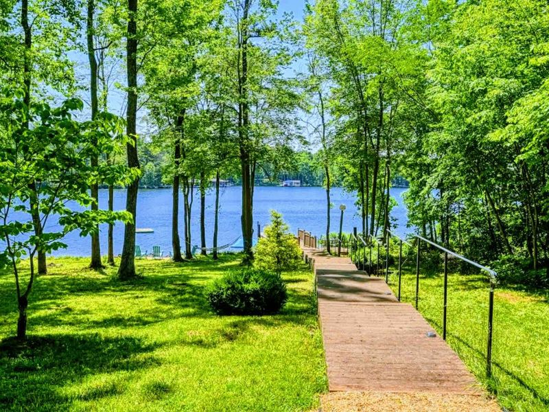 Stroll down this peaceful path to your private dock and take in the serene lake views surrounded by lush greenery.
