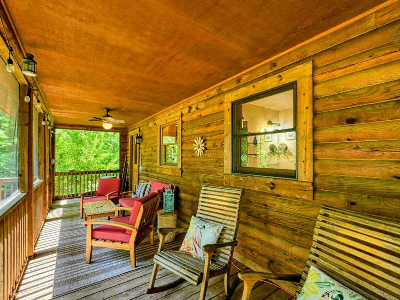 Relax and unwind on the cozy screened-in porch, perfect for enjoying peaceful mornings or evenings surrounded by nature.