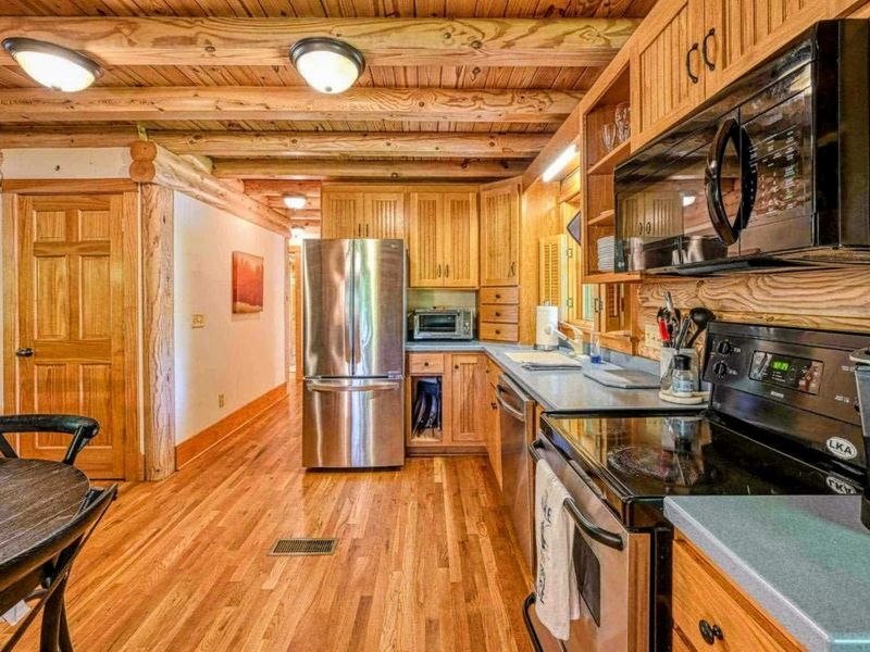 Step into this spacious kitchen, fully stocked with everything you need to prepare your favorite meals while surrounded by the warmth of natural wood accents.