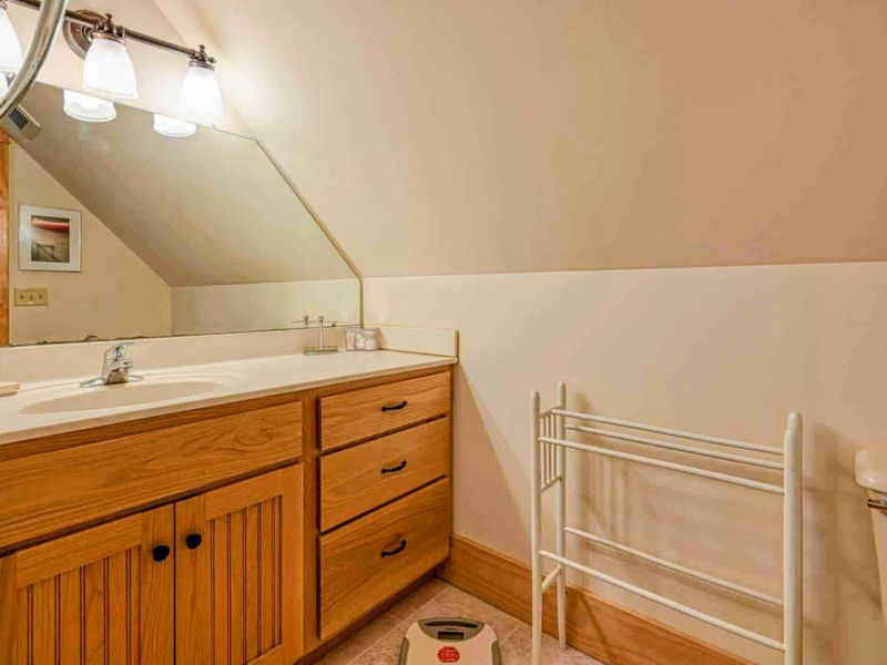 Enjoy the comfort and convenience of our thoughtfully designed bathroom, featuring cozy wooden cabinetry and ample space to refresh.