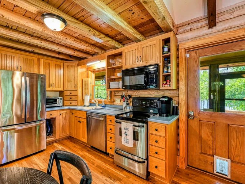 Enjoy the perfect blend of rustic charm and modern convenience in this fully equipped kitchen, ideal for preparing meals after a day of lakefront fun.