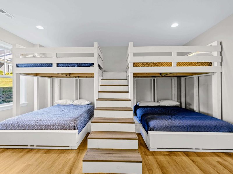 Bunk Room - Symmetrical bunk wall flanks the central staircase, putting four big beds within steps of each other.