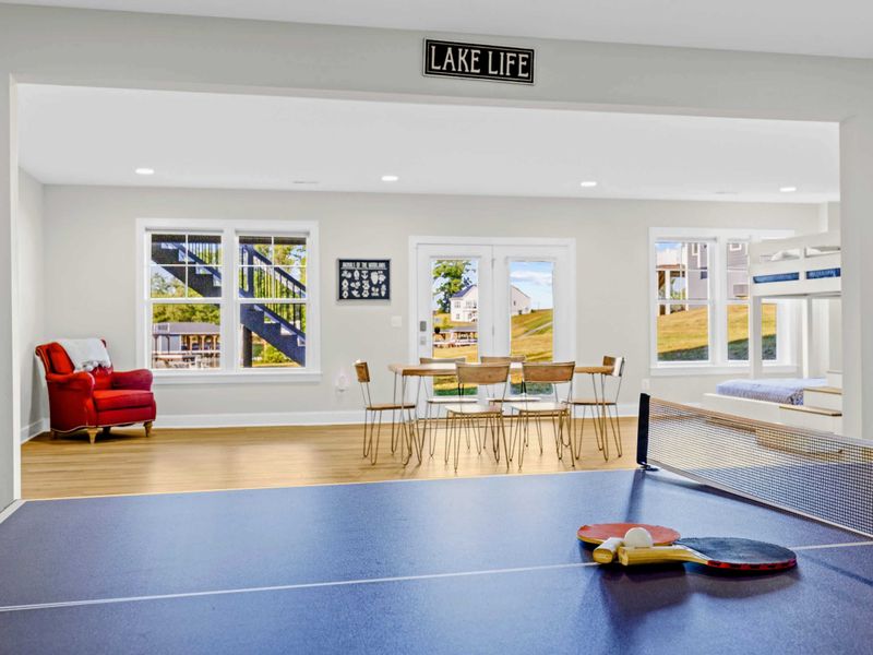 Game Room - Ping pong in the foreground, dining nook and bunk room peeking out under the Lake Life sign in back.