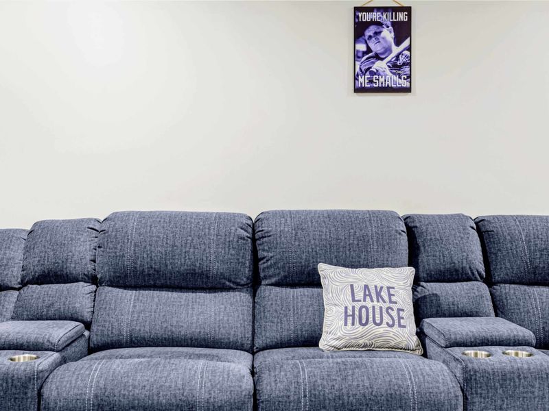 Theater - Close-up of the sectional with cup holders, Lake House pillow, and a Sandlot 'You're killing me Smalls' print.