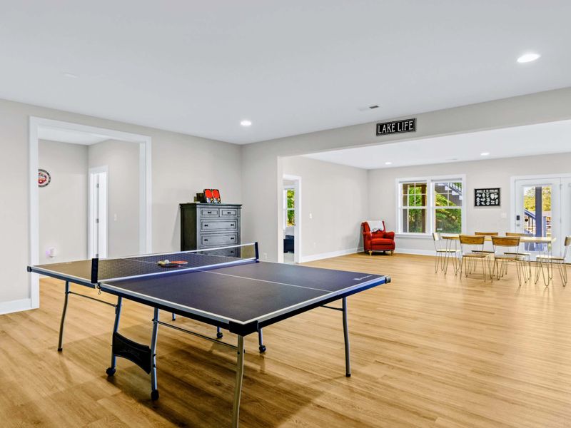 Game Room - Ping pong up front, dining nook and Lake Life sign in the back, with the custom bunk room just beyond.