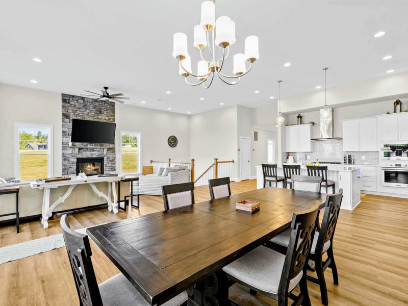 Dining Area - Wide-angle of the eight-seater with the great room fireplace and kitchen all in one open layout for the whole group.
