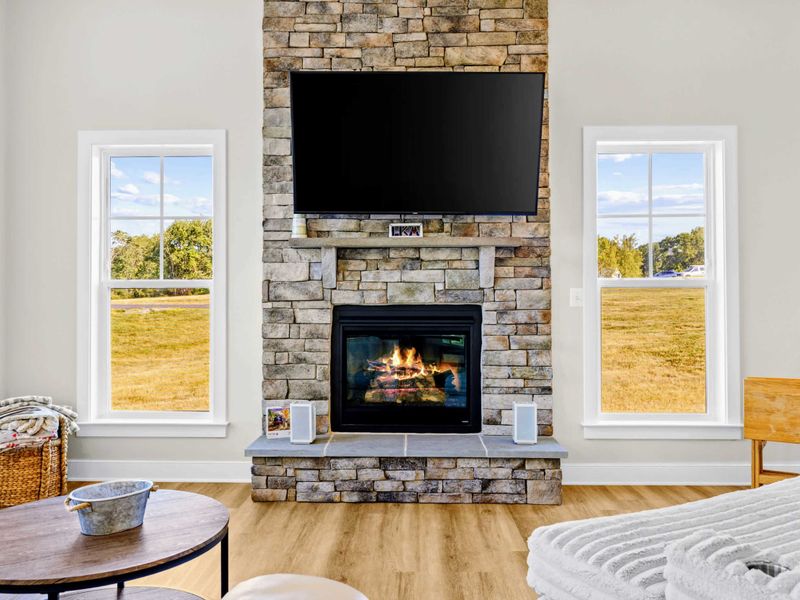 Great Room - The gas fire lit on a quiet evening, tall windows over the yard, and a sofa shaped for the whole group.