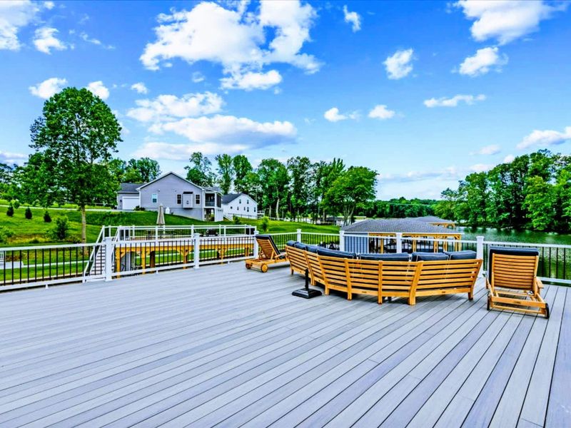 Sun Deck - Plush teak loungers, lake views in every direction, the most-used outdoor room from morning coffee to last light.