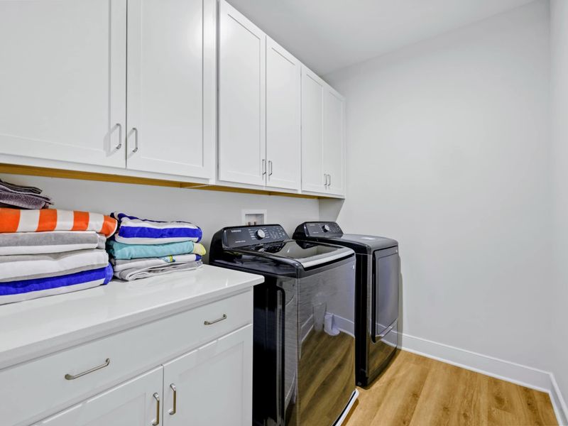 Laundry - Full-size washer and dryer with cabinet storage, stocked beach towels, and folding counter for easy turn-arounds.