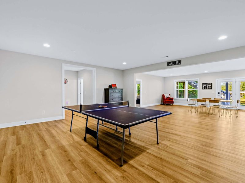 Game Room - Tournament-ready ping pong table, with the patio doors letting the afternoon light in from the backyard.