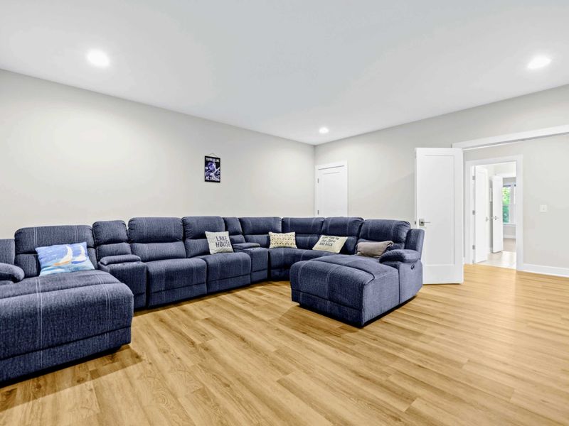 Theater - Wide view of the sectional and the walkway out to the lake-level hall, easy in and out for snack refills.