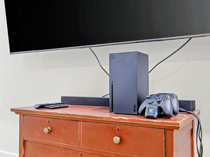 Theater - The big screen, soundbar, and Xbox Series X set up on the rustic media cabinet, ready for movies or games.