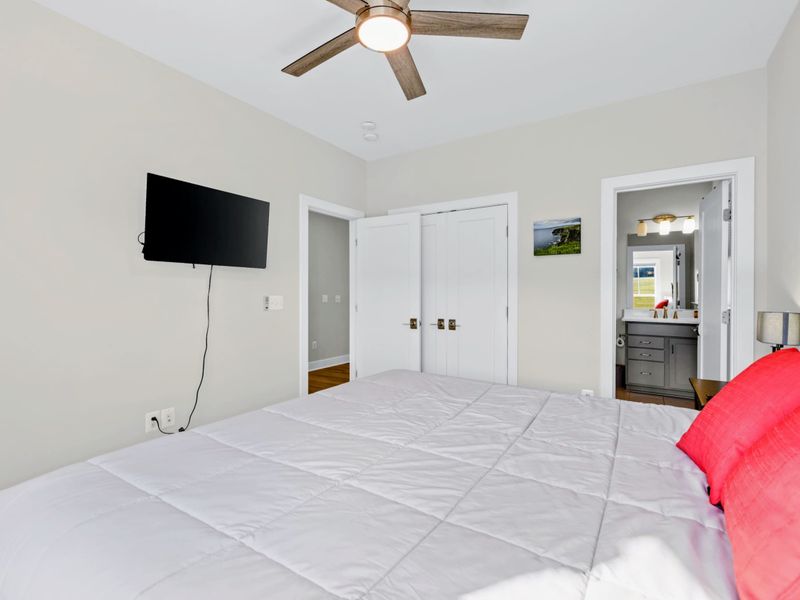 Suite 2 - King bed with a mounted TV across the room and direct ensuite bath access through the side door.