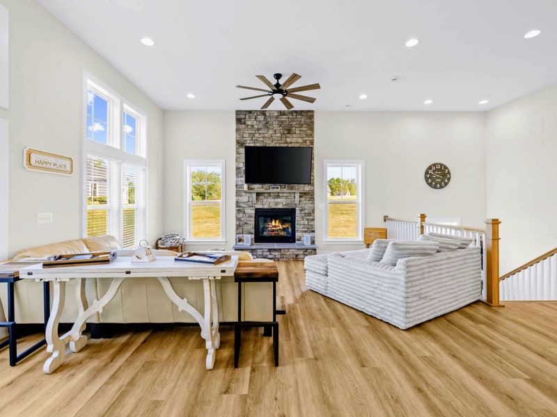 Great Room - The corduroy sectional and oversized lounger face the stone fireplace, with a console table set for game nights.