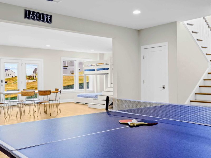 Game Room - Ping pong, dining nook, and the staircase up, all flowing into the bunk room next door.