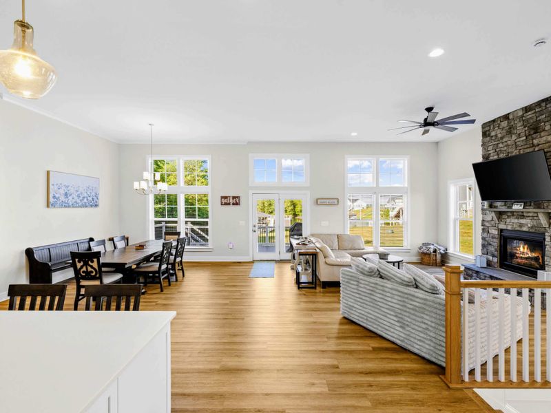 Great Room - Soaring windows, a stone fireplace, and a sectional built for the whole crew, all opening onto kitchen and dining.