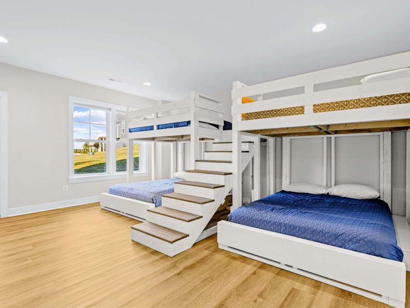 Bunk Room - Two queens on the bottom, lofted bunks above, and sturdy stairs in between, designed so sleepovers feel like an event.