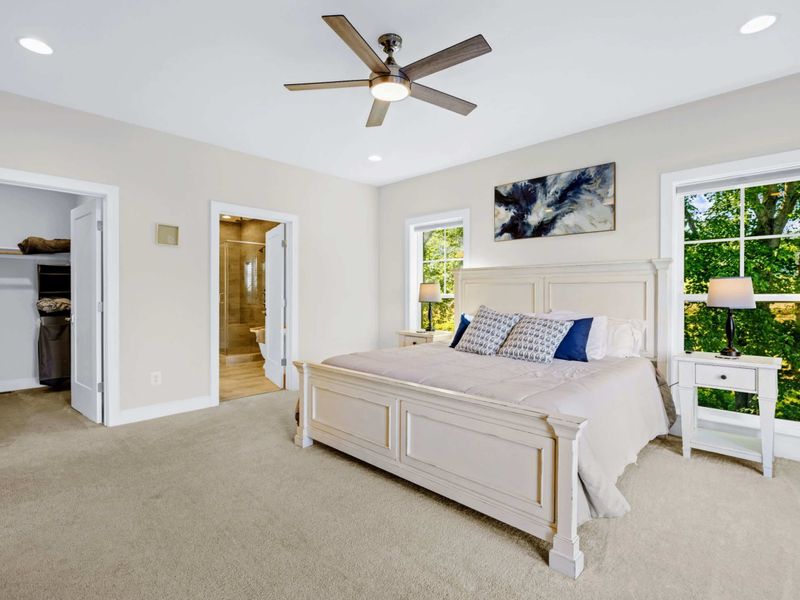 Primary Suite - King bed with a walk-in closet and the ensuite bath just through the doorway, all opening to the great room.