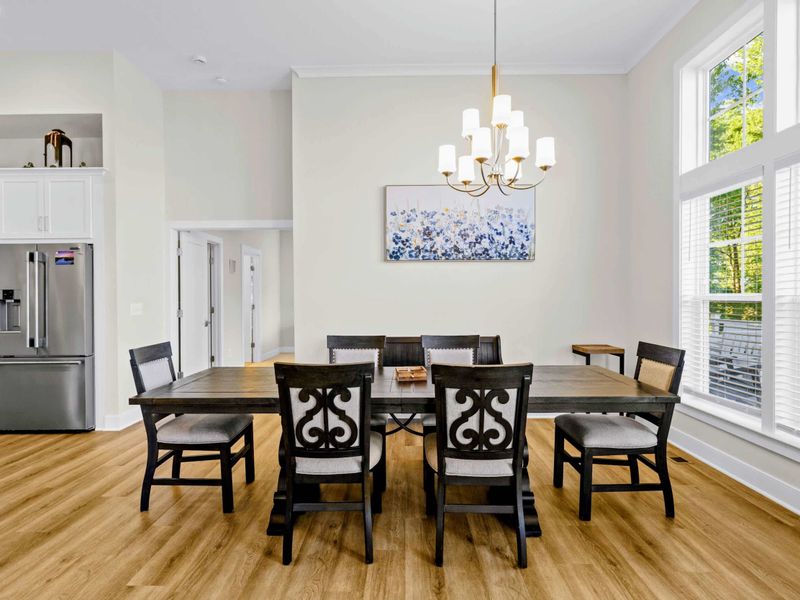 Dining Area - Six-seat table sits between the open kitchen and a wall of windows, ready for family meals and long game nights.