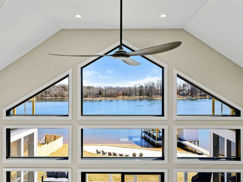 Breathtaking Lake Views: Stunning floor-to-ceiling windows frame picturesque waterfront scenery, filling the home with natural light and offering unparalleled panoramic views of Lake Anna.