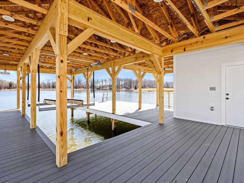 Covered Boat Dock: Spacious, well-designed dock with a boat slip, ample seating, and stunning waterfront views, perfect for enjoying Lake Anna in comfort and style.
