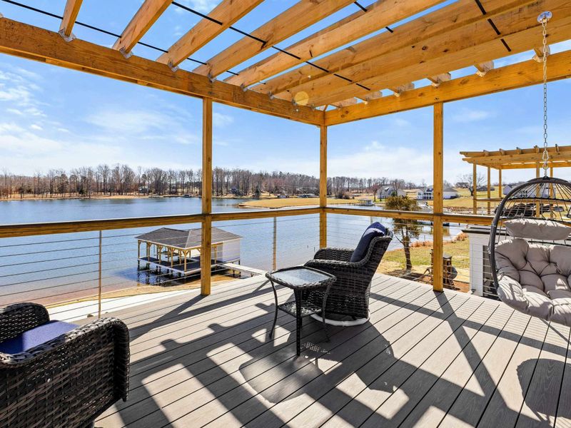 Suite #3 Private Balcony: Stunning pergola-covered balcony featuring cozy seating, a hanging egg chair, and breathtaking panoramic views of Lake Anna—perfect for relaxing in the fresh air.