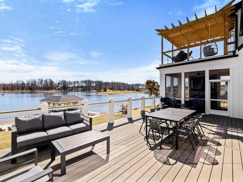 Lakeside Lounge Deck: Spacious deck featuring cozy seating, an outdoor dining area, and stunning panoramic views of Lake Anna—perfect for relaxing, entertaining, and soaking up the tranquil waterfront atmosphere.