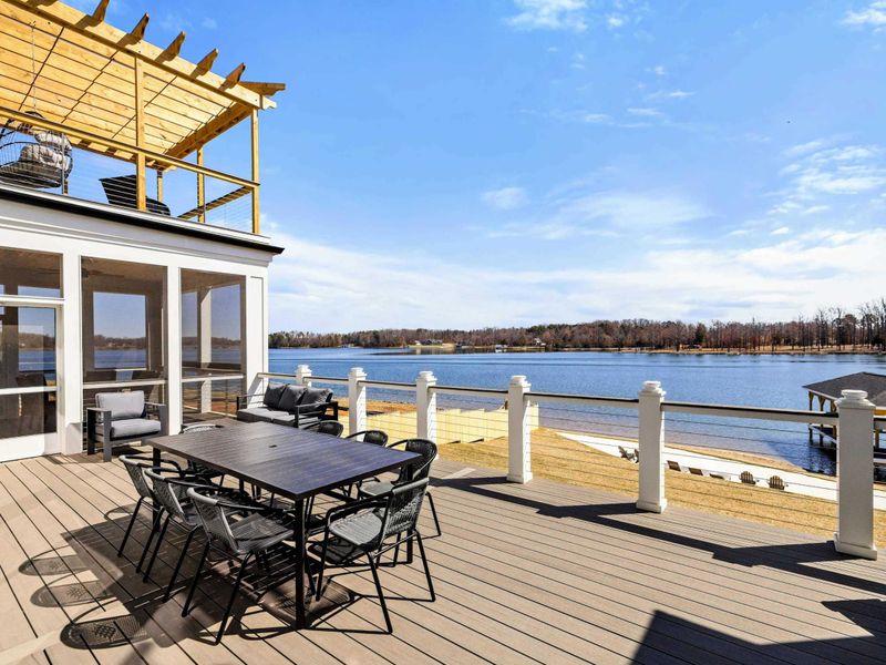 Expansive Deck: Stunning outdoor deck with ample seating, a pergola-covered lounge area, and breathtaking lake views—perfect for dining, entertaining, and soaking in the serene surroundings of Lake Anna.