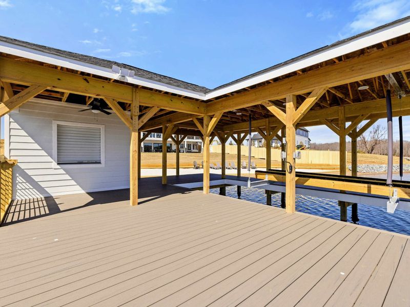 Covered Pavilion Dock: Thoughtfully designed dock with a shaded pavilion, boat lift, and ample space for lakeside lounging, offering the perfect blend of relaxation and convenience on Lake Anna.