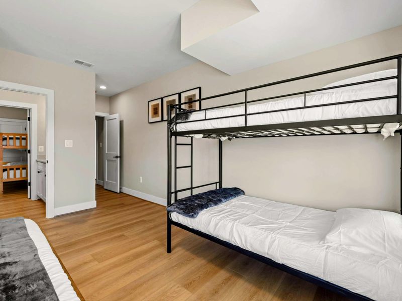 Suite #7: Features a king bed and a twin-over-twin bunk bed. Connected to a Jack & Jill style shared bathroom for added convenience.