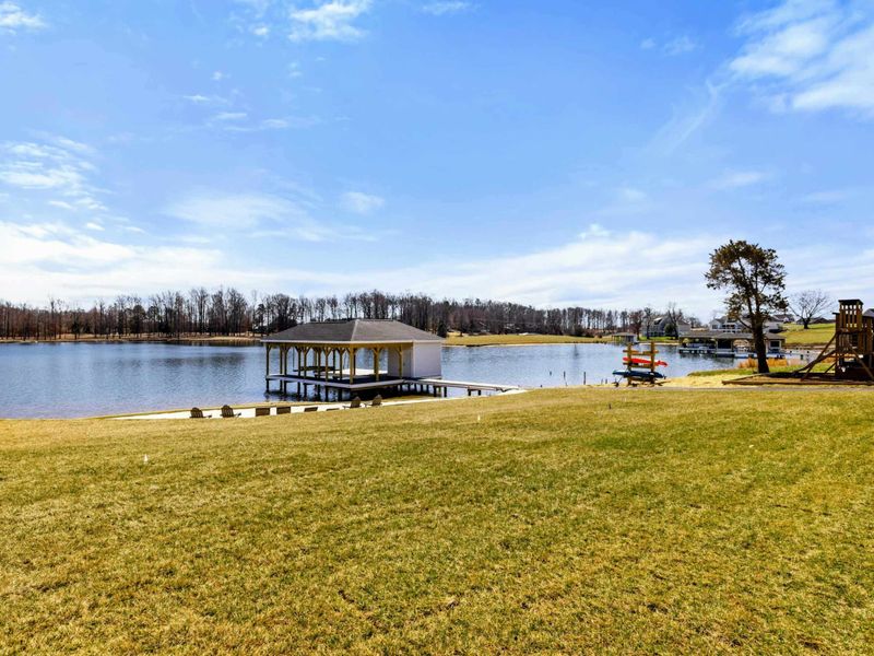 Spacious Lakeside Lawn: Expansive grassy lawn ideal for outdoor games and relaxation, gently leading to your private beach, dock, and children's play area by picturesque Lake Anna.