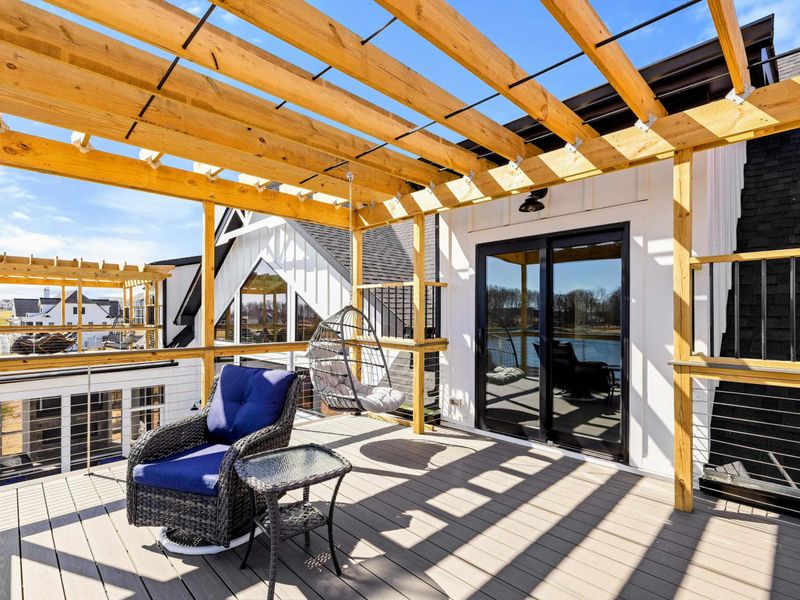Suite #3 Pergola-Covered Balcony: Charming private balcony with a stylish pergola, cozy seating, and a hanging egg chair, offering a perfect spot to unwind while enjoying beautiful lake views.
