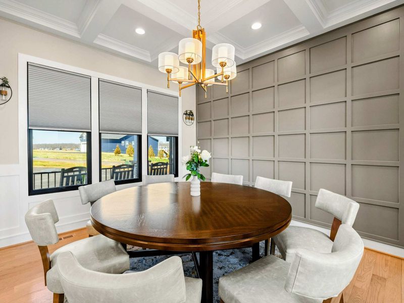 Elegant Dining Room: Sophisticated dining space featuring a rich wood table, plush seating, a statement chandelier, and a stylish accent wall, creating the perfect setting for intimate meals and gatherings.