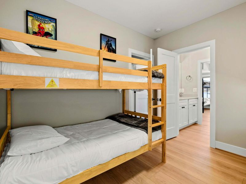 Suite #8: Offers two wooden bunk beds and fun decor, making it a great space for kids or extra guests. Conveniently connected to a Jack & Jill bathroom for easy access.