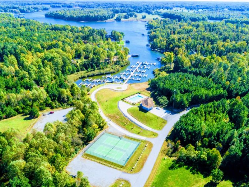 Amenities From Above - Tennis courts, the clubhouse and pool, and the marina line the community's cove, minutes from the front door.