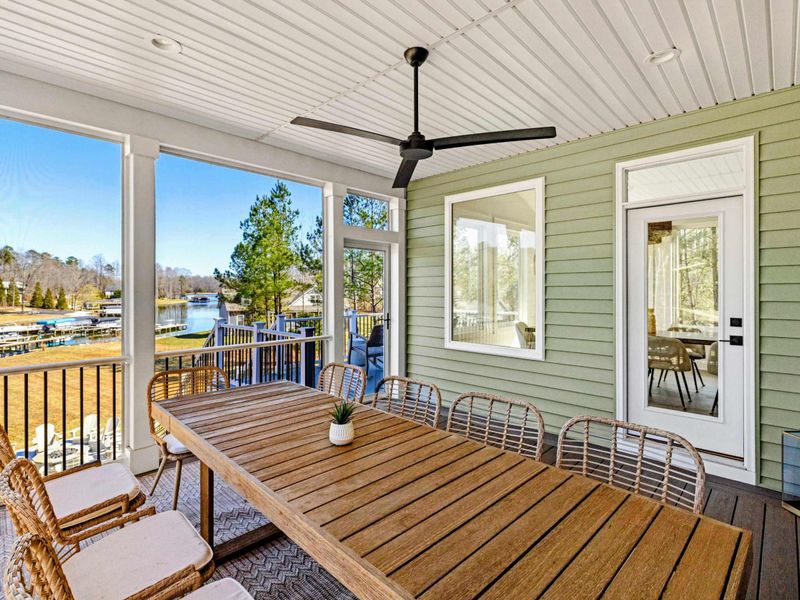 Screened Porch - A long farmhouse table seats the whole group for lakeview dinners, ceiling fan overhead and the breeze off the water, bugs left outside.