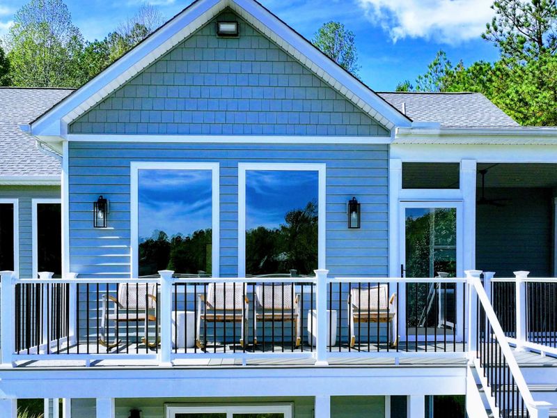 Lakeview Deck - Woven chairs line the rail for sunset watching, the screened porch alongside and Lake Anna stretching out below.