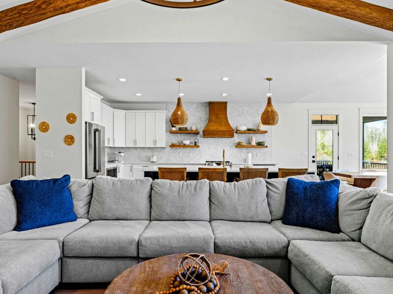 Connected Living - From the sectional, the kitchen island and dining sit in full view, the heart of the home gathered into one bright space.