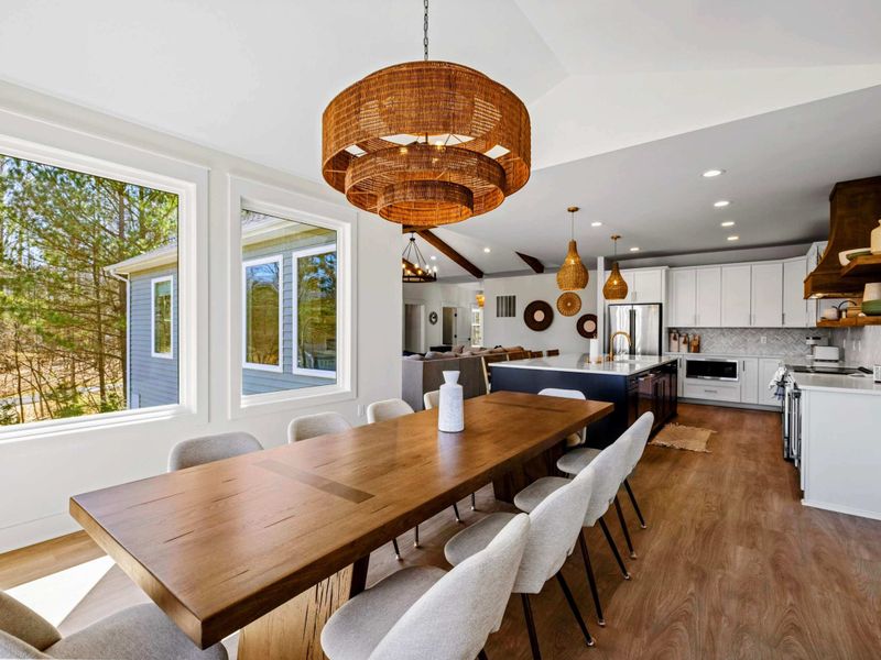 Dining Room - A live-edge walnut table seats the group beneath a woven drum chandelier, steps from the kitchen and open to the lake views. (now with 12 seats!)