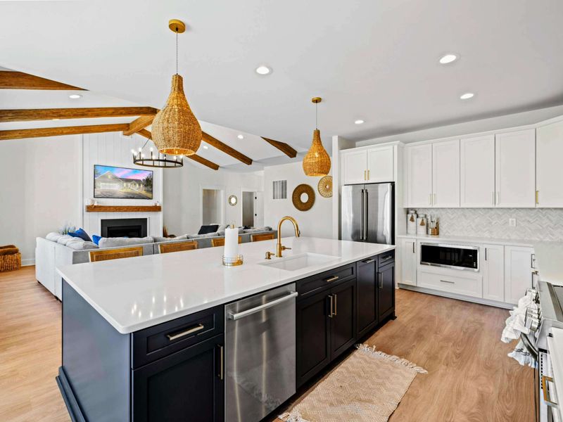 Heart of the Home - The oversized island opens straight to the great room and its fireplace, so the cook is never far from the conversation.