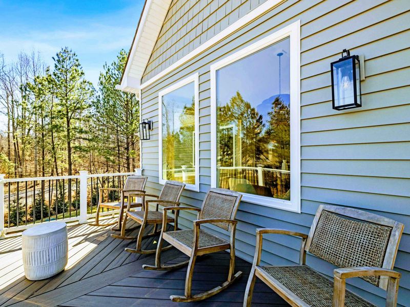 Deck Rockers - A row of woven rockers faces the water, the spot for morning coffee or a quiet afternoon breeze above the lake.