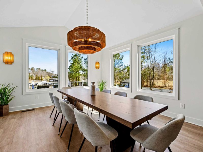 Dining Room - A long walnut table seats ten under a woven drum chandelier, framed by a wall of windows with the kitchen just steps away. (now with 12 seats!)