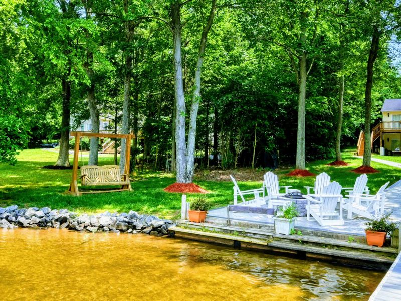 Lakefront Leisure Corner – Enjoy this cozy lakeside nook, complete with Adirondack chairs and a charming swing. A peaceful setting for relaxation and casual conversations by the waters of Lake Anna.