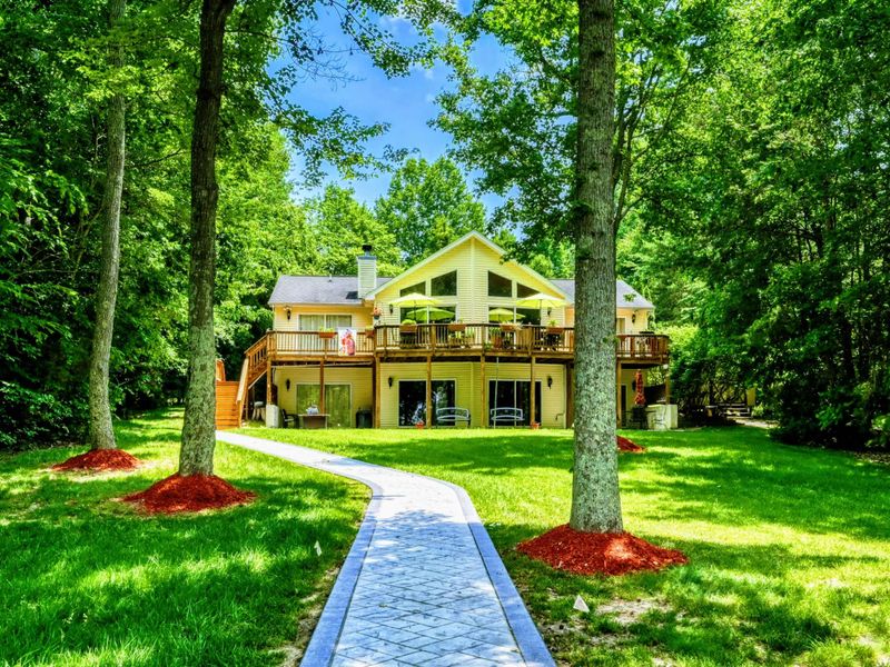 Lakefront Luxury at Lake Anna – Experience the ultimate retreat in this stunning home, surrounded by lush greenery and just steps away from the lake. Featuring spacious decks and scenic views, it’s perfect for relaxing in nature’s embrace.