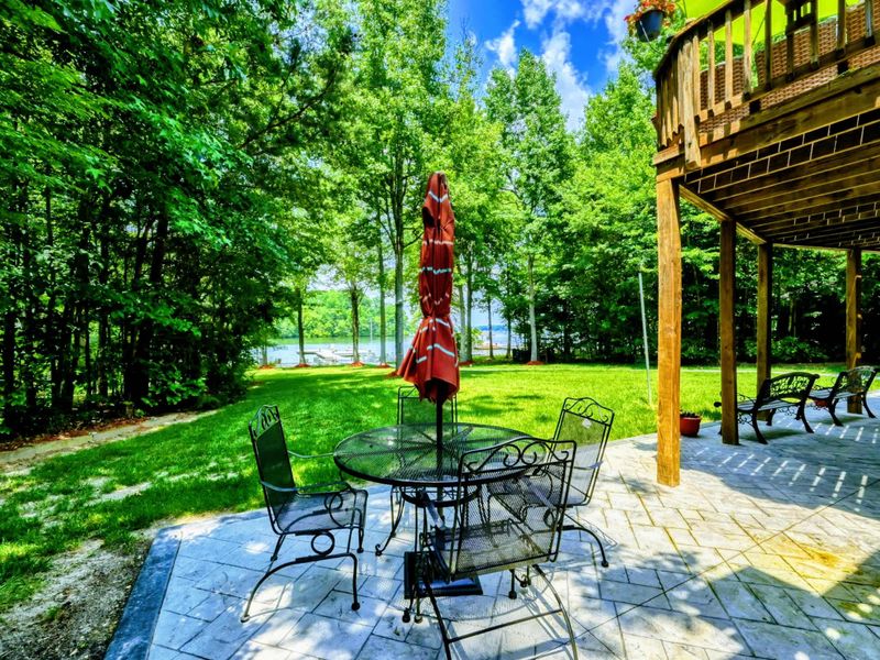 Shaded Lakeside Patio – Enjoy this peaceful outdoor setting, featuring a shaded patio with comfortable seating, nestled among trees with a view of Lake Anna. Perfect for cool afternoons or intimate gatherings.