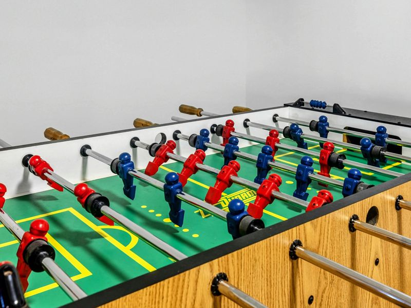 Foosball Fun – Kick off some friendly competition with a classic game of foosball! This vibrant table is ready for action and adds even more excitement to the game room experience.