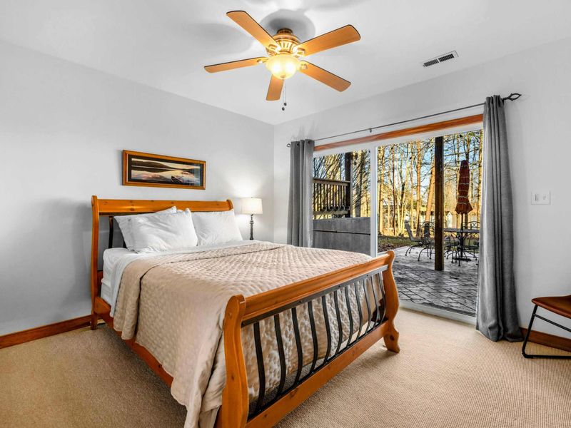 Private Patio Access – This inviting bedroom features direct access to the lower patio, offering peaceful views and easy indoor-outdoor living by the lake.